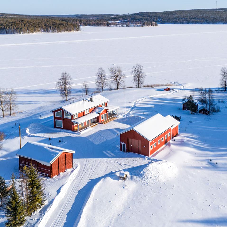 Villa Lehtoniemi and its outbuildings on the shore of a frozen lake near Rovaniemi